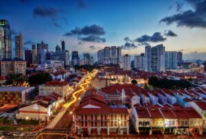 A stunning view of the Singapore skyline at dusk, showcasing illuminated skyscrapers against a twilight sky