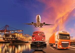  A large truck is parked at a port while an airplane flies overhead, showcasing transportation and logistics in action.