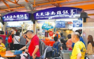 A queue of people at a lively food market, highlighting the social aspect of shopping for fresh and local produce.