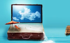 A suitcase accompanied by an umbrella and a beach chair set against a picturesque ocean backdrop.