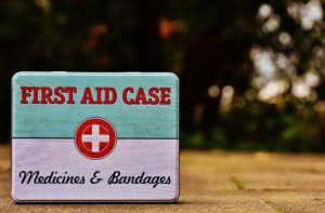 A first aid case containing various medical supplies, including bandages and medicine, ready for emergency use.