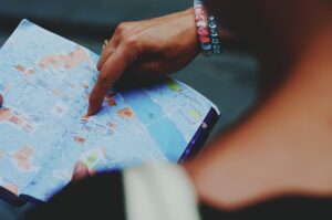 A person points to a map they are holding, indicating a specific location or route.