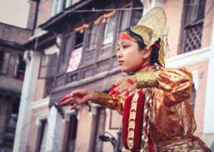 A woman in traditional costume performs a vibrant dance in the street, showcasing cultural heritage and joy.